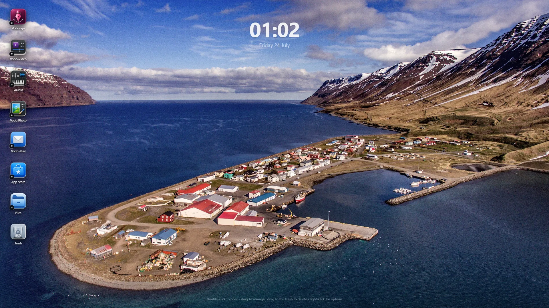 Vodomation OS desktop with a glass-style app dock over a coastal landscape